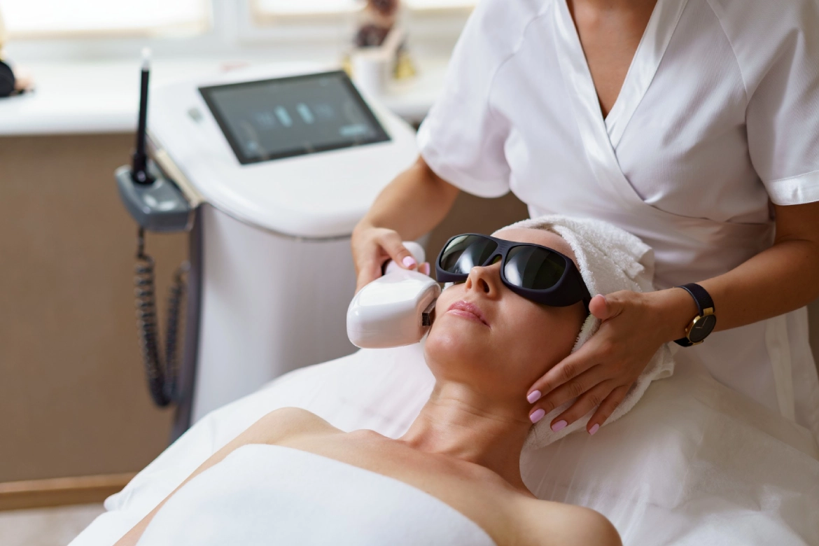 Mulher branca deitada na maca fazendo radiofrequência facial